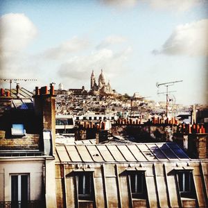 Buildings against cloudy sky