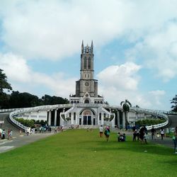 People at temple against sky