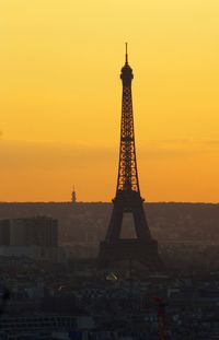 Tower in city at sunset