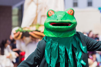 Person wearing frog costume during parade
