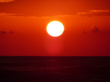 Scenic view of sea against romantic sky at sunset