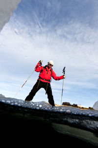 Low angle view of person standing on snow against sky