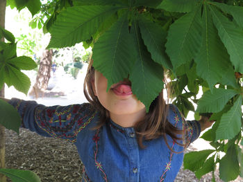 Close-up of girl licking leaves