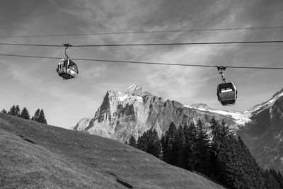 Low angle view of overhead cable car against sky