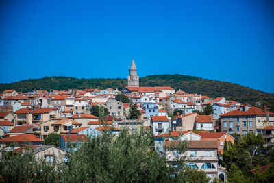 High angle view of townscape against clear blue sky