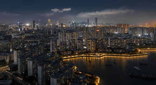 High angle view of illuminated buildings against sky at night