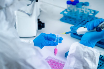 Midsection of scientist working in laboratory