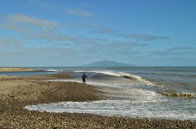 Man on beach against sky