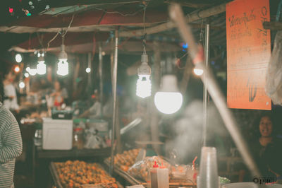 Illuminated street lights in restaurant at night