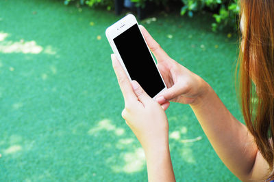 Midsection of woman using mobile phone