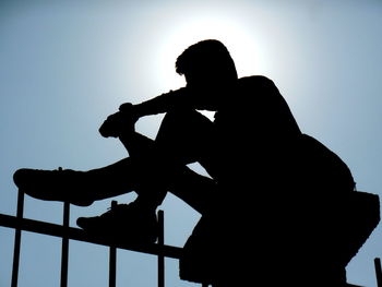 Low angle view of silhouette man against clear sky