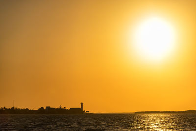 Scenic view of sea against orange sky