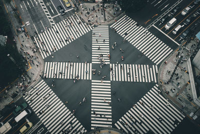 Aerial view of people walking on crosswalk in city
