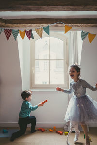 Girl and boy playing at home