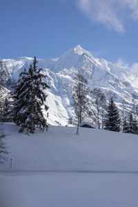 Scenic view of snow covered mountains against sky