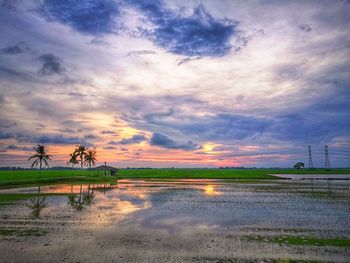 Scenic view of beach against dramatic sky