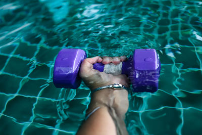 Midsection of woman in swimming pool