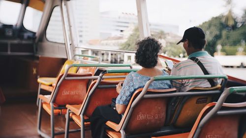 Rear view of people sitting in bus