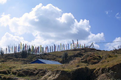 Flags on hill against blue sky