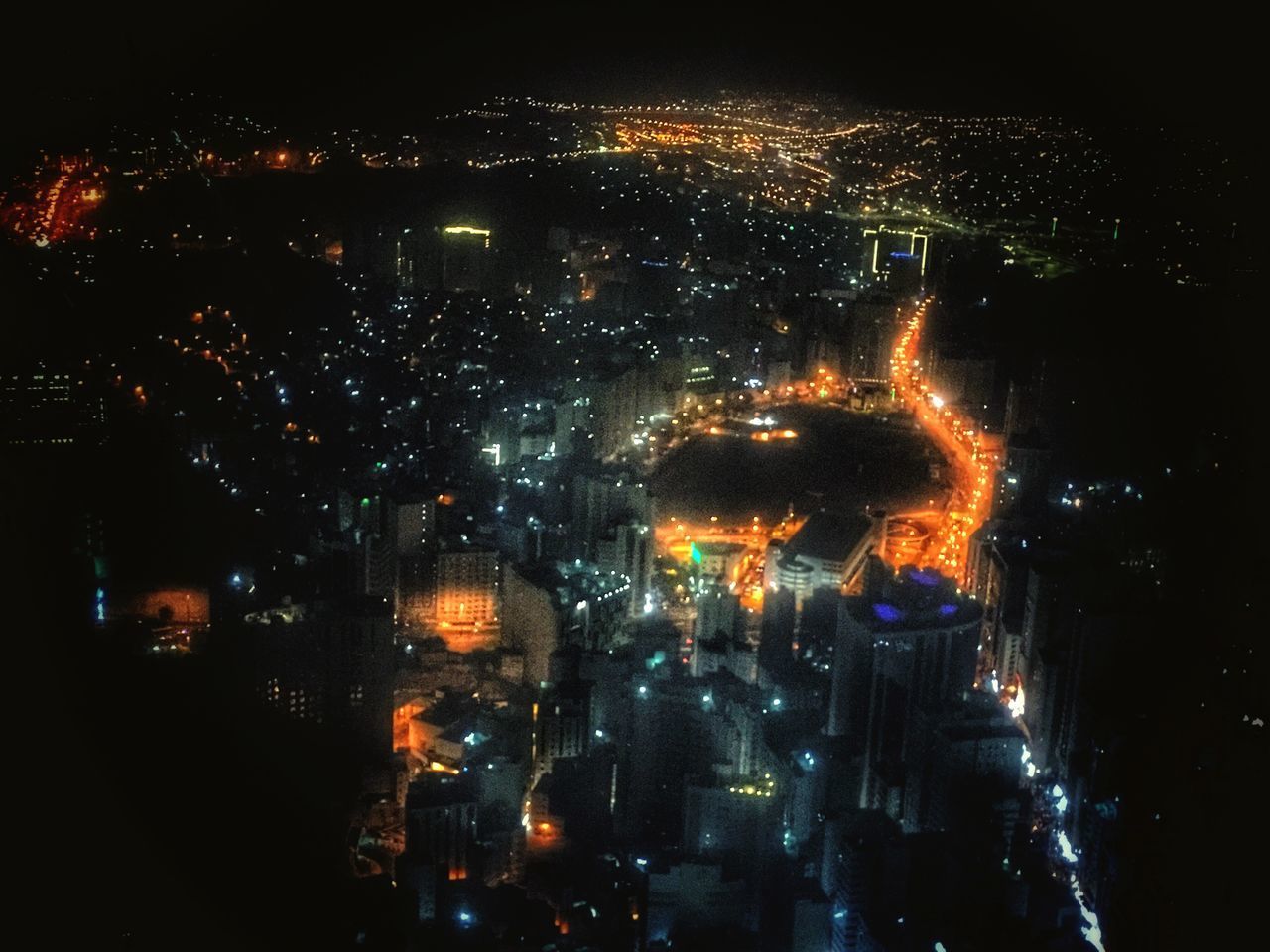 ILLUMINATED BUILDINGS IN CITY AT NIGHT