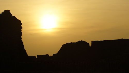 Silhouette of built structures at sunset