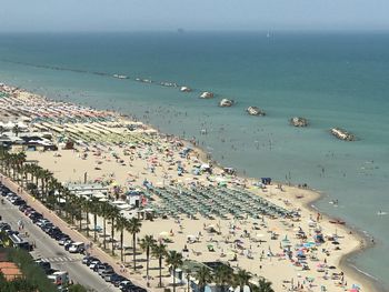 High angle view of crowd at beach against sky