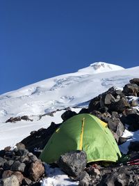 Scenic view of snowcapped mountains against clear blue sky