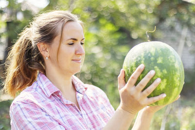 Young woman holding globe