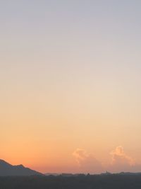 Scenic view of silhouette mountains against sky during sunset