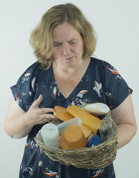 Mid adult man holding camera over white background