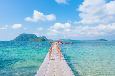 Beautiful tropical beach sea and sand with floating walkway pontoon in andaman sea thailand.