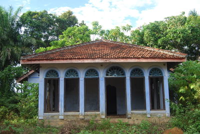 Exterior of house on field against sky