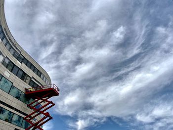 Low angle view of buildings against cloudy sky