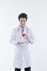 Full length of young man standing against white background