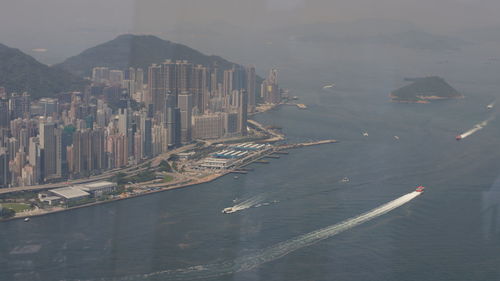 High angle view of city buildings by sea