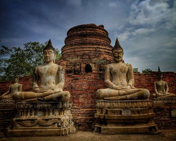 Statue against temple against sky