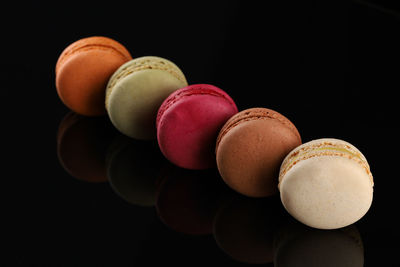 Close-up of macaroons against black background