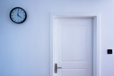 Clock on wall by door at home