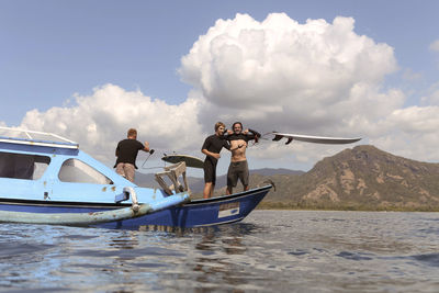 Men standing at the boat into sea