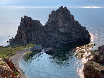 Rock formation on sea against sky