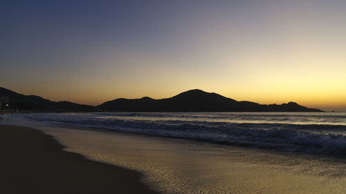 Scenic view of sea against clear sky during sunset