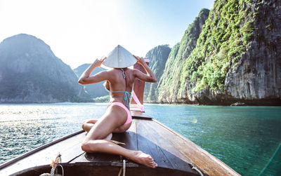 Woman on longtail boat in sea