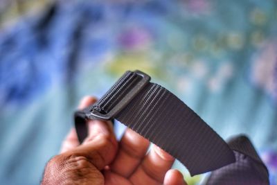 Close-up of man holding cigarette against blurred background