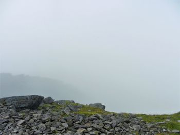 Scenic view of mountains against sky during foggy weather