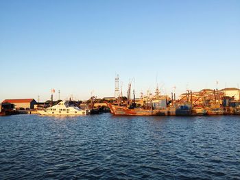 Boats moored at harbor