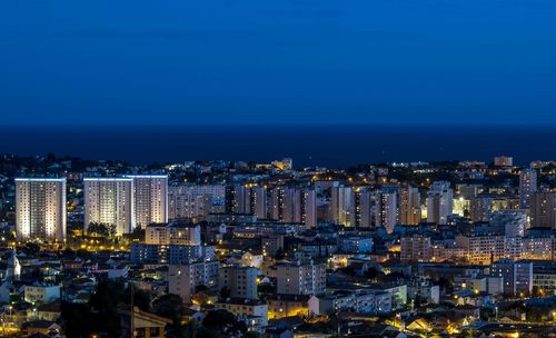 High angle view of city lit up at night