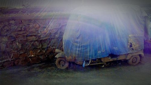 Side view of abandoned car on road