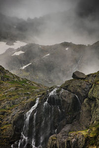 Scenic view of waterfall against rock formation