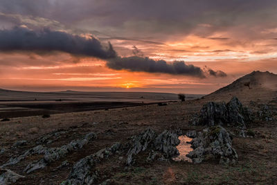 Scenic view of landscape against sky during sunset