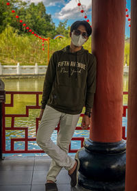 Portrait of young man standing in city